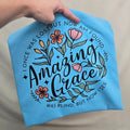 Comfort Colors short sleeve tee with floral Amazing Grace design and the words I once was lost but now am found, was blind but now I see
