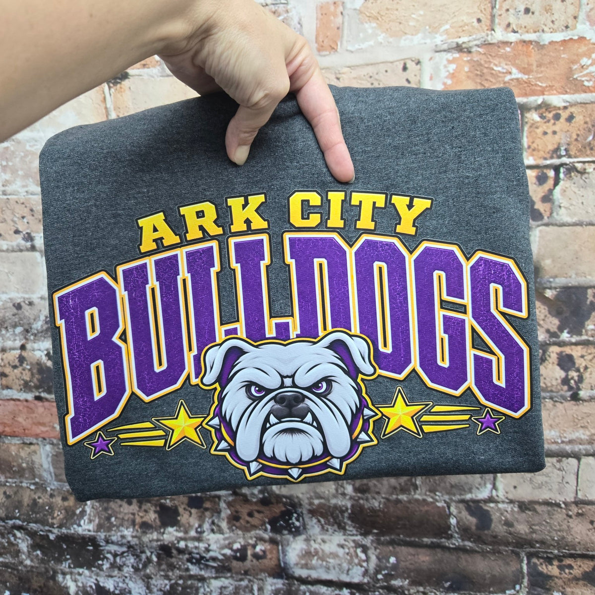 Heather charcoal Comfort Colors short sleeve tee featuring Ark City Bulldogs in purple and gold with bulldog graphic