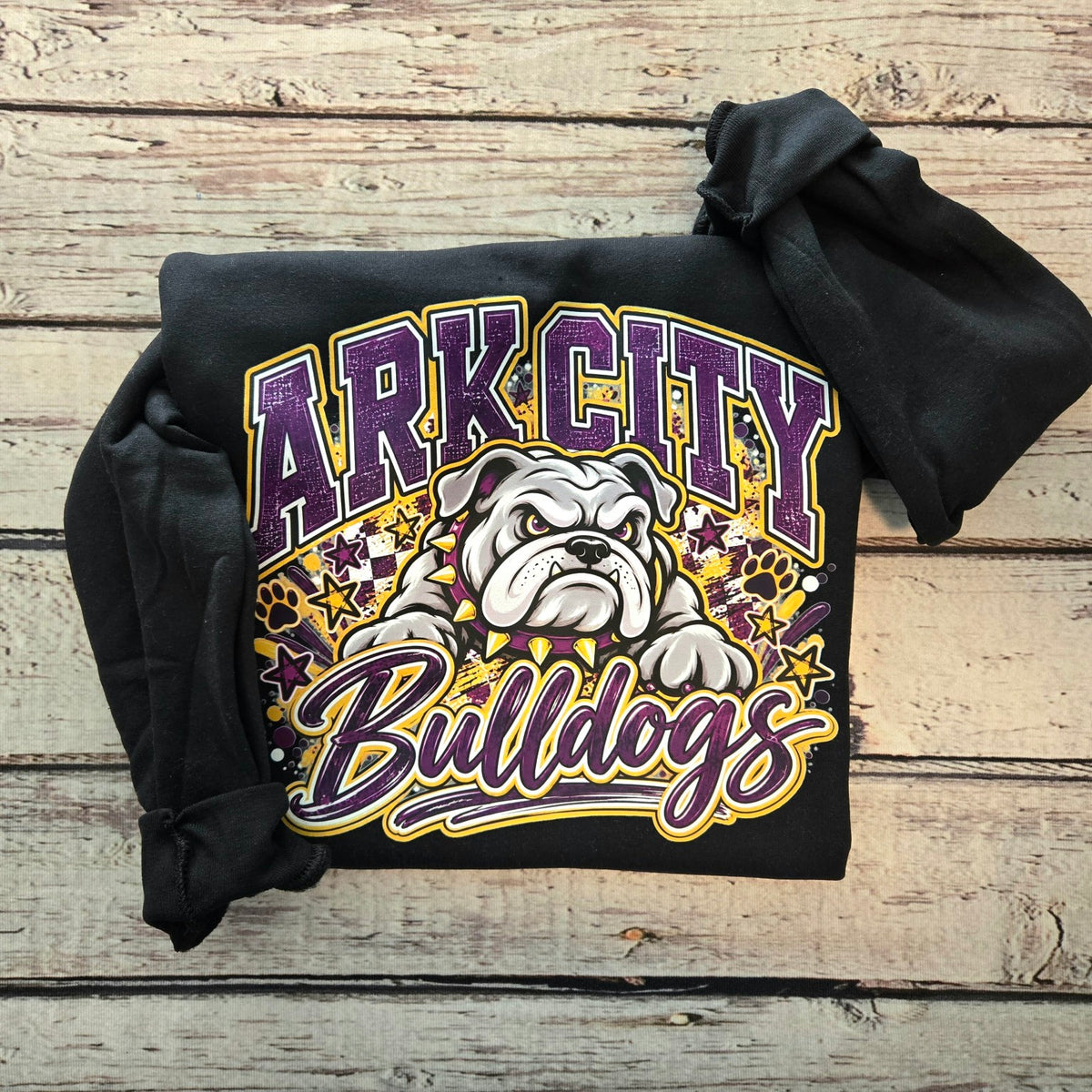 Black Gildan crewneck featuring Ark City Bulldogs bulldog mascot with purple and gold distressed varsity design