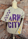 Heather gray Gildan crewneck with purple Ark City Bulldogs lettering and paw prints on sleeves