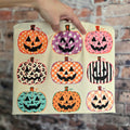 Cream Comfort Colors short sleeve tee with nine colorful patterned jack-o-lantern pumpkins
