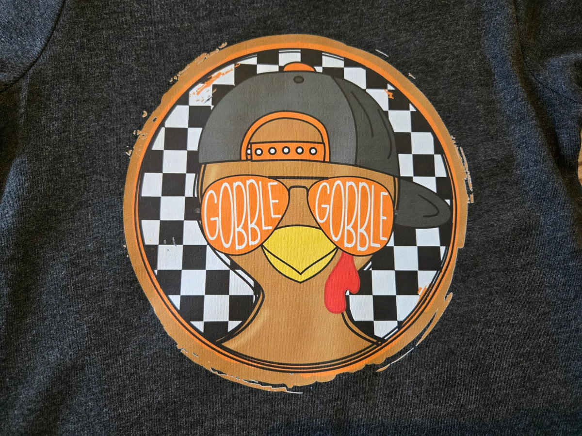 Boy Gobble Gobble turkey design wearing a cap and orange sunglasses